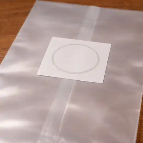 Close-up view of 0.2 micron filter patch on polypropylene grow bag, designed for sterile gas exchange during grain colonization.